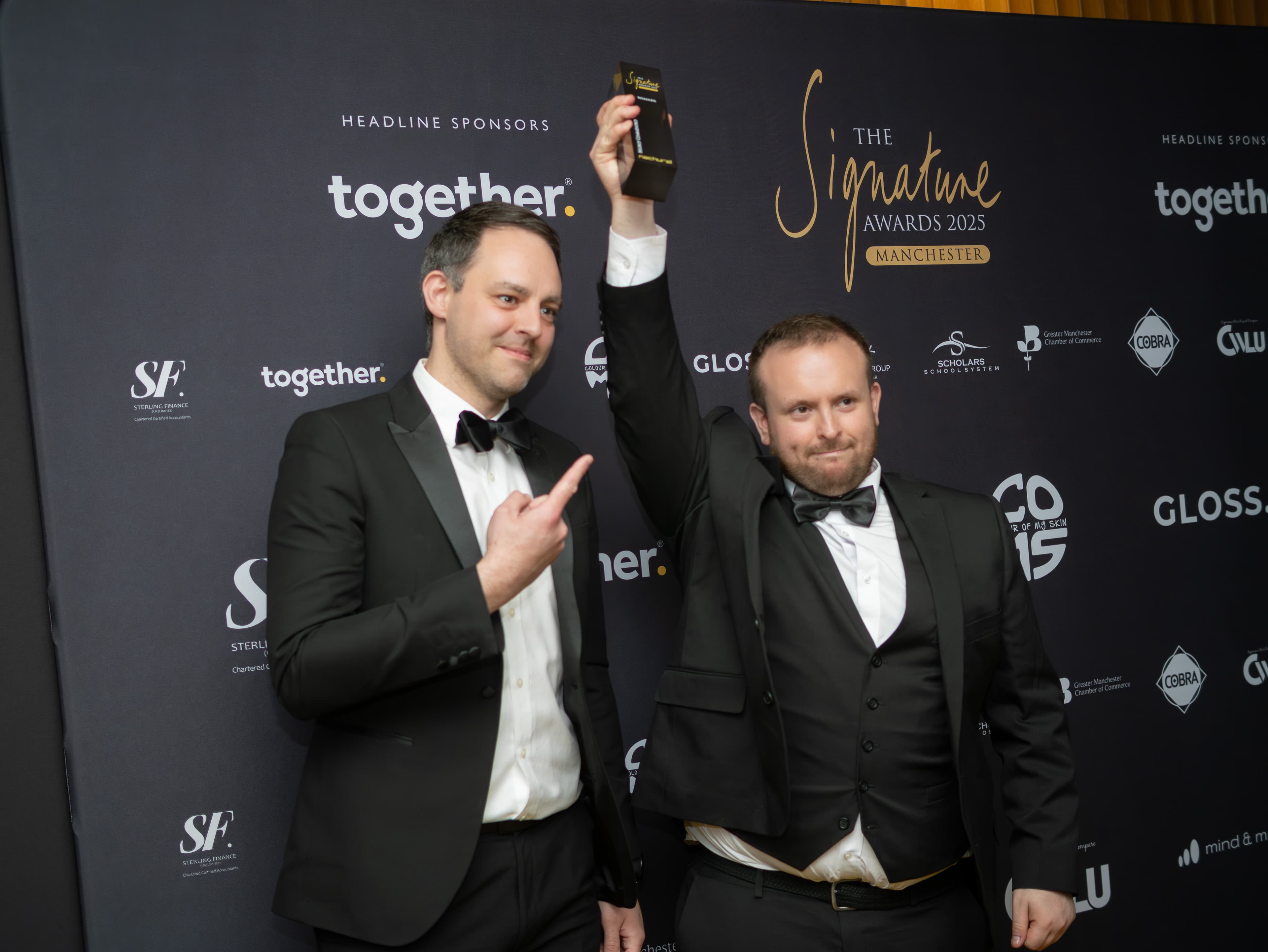 Sam holding the award aloft